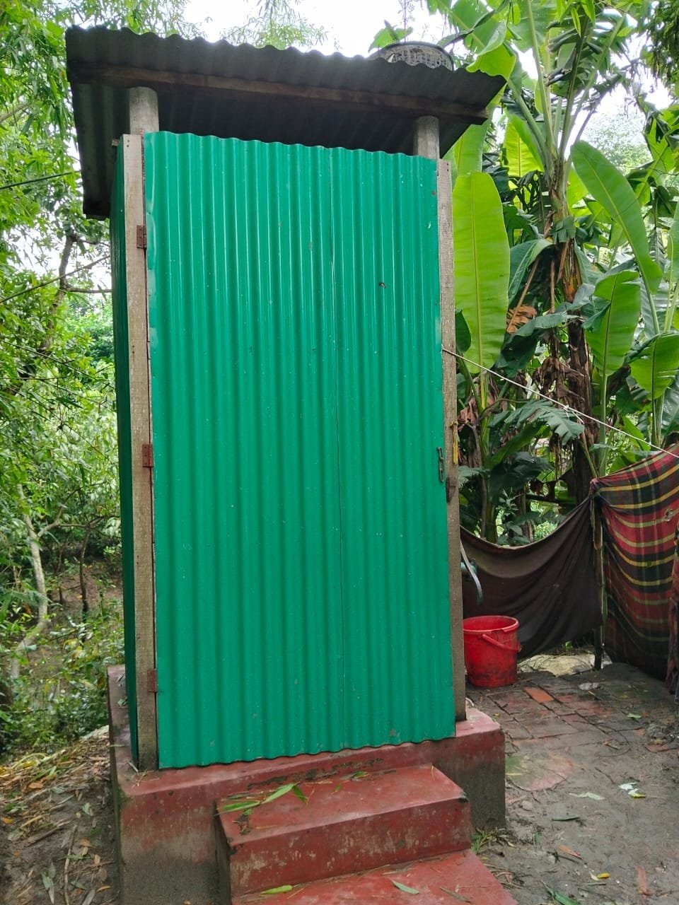 New green tin latrine.